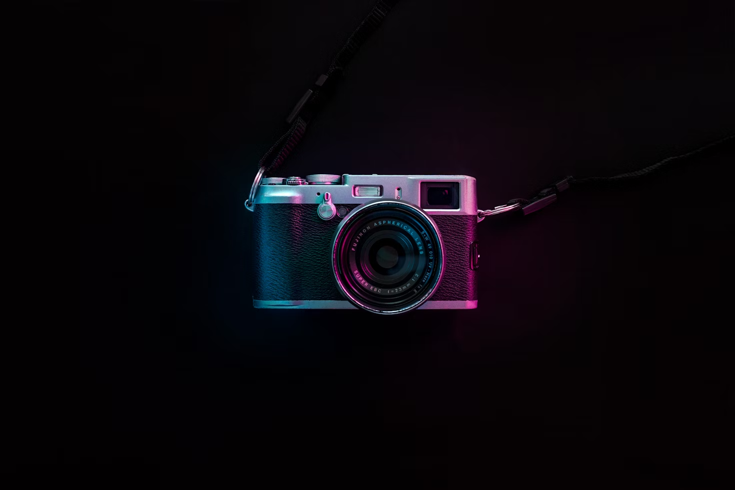 Camera with neon lighting on a dark background